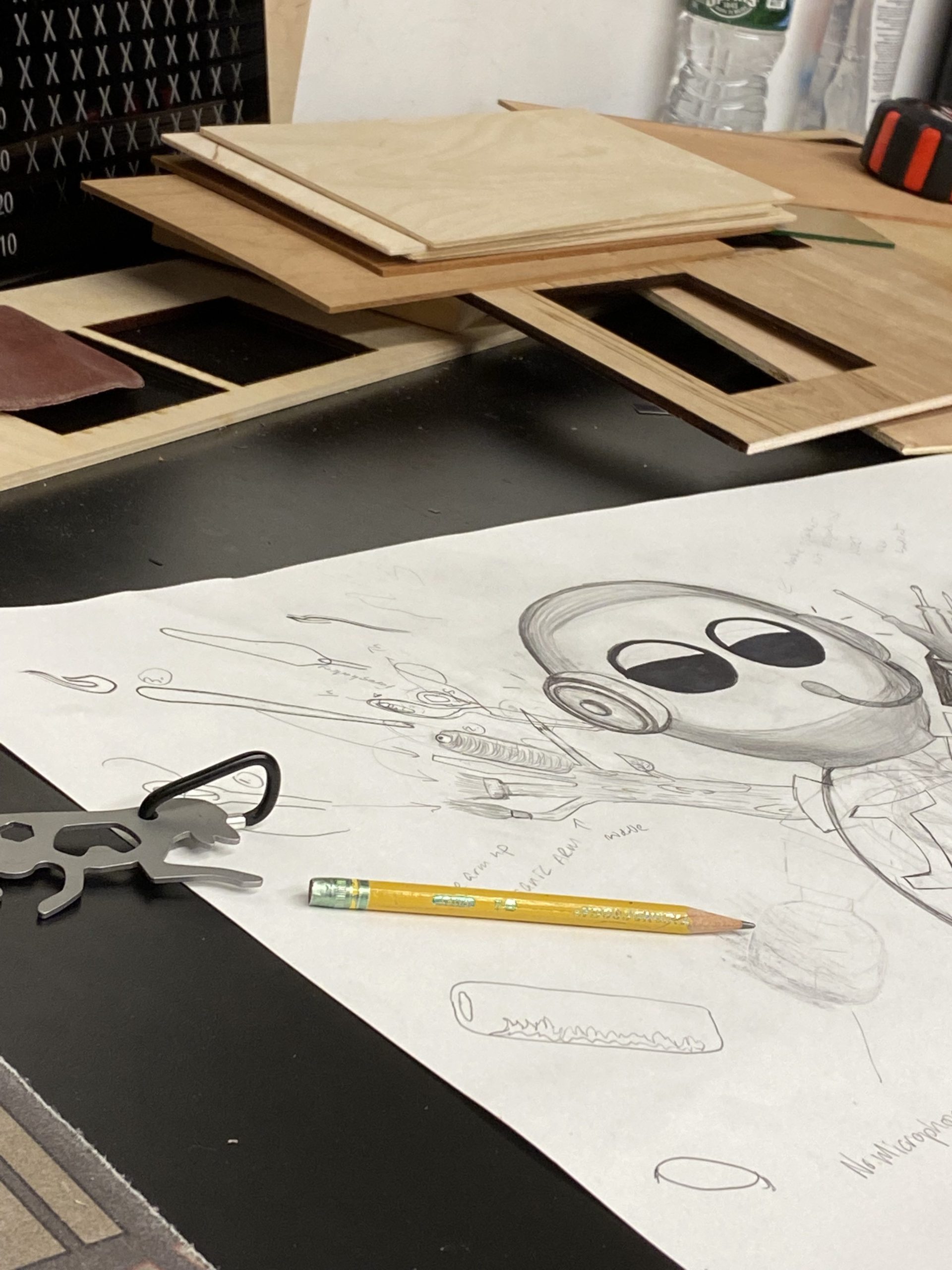 Art of MRC (pronounced Mercy) Robot drawn with pencil and paper spread out on a desk