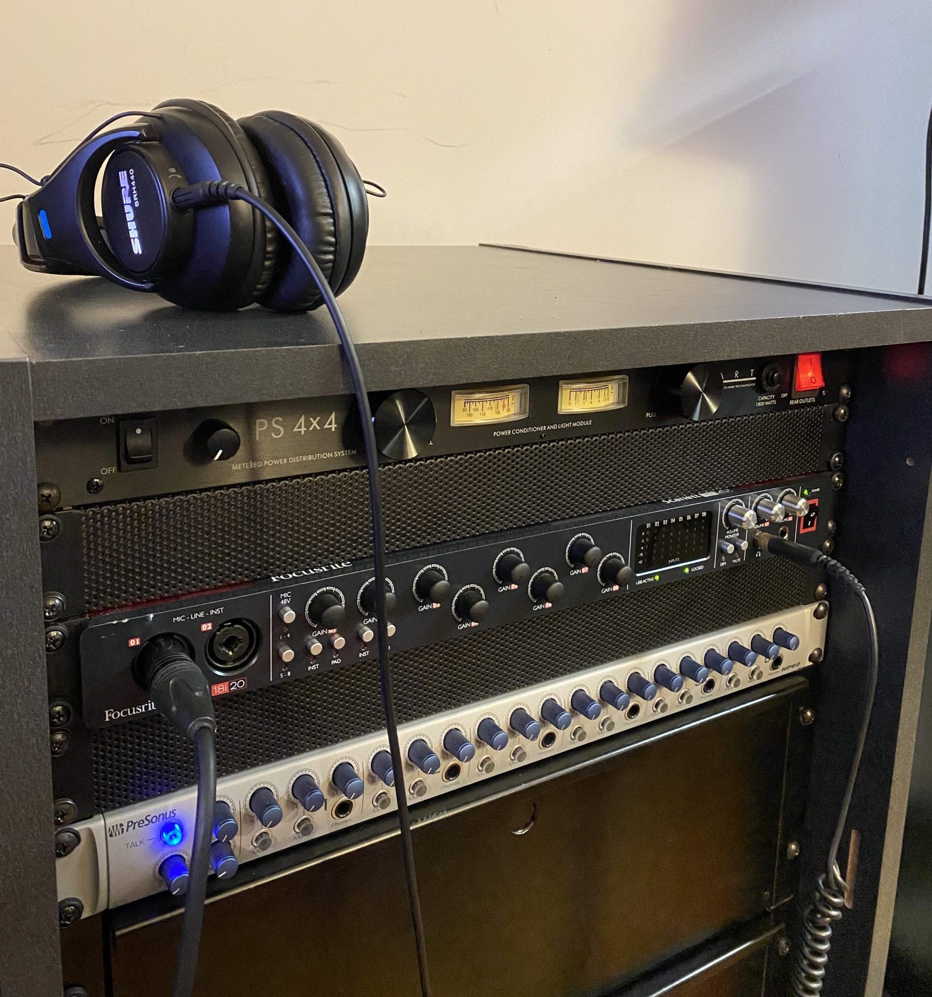 Headphones resting on audio equipment rack in the IMRC Center Electronic Music Production Lab